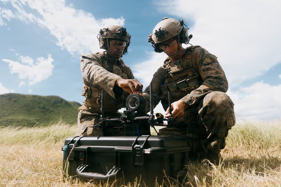 U.S. Marine Corps riflemen with Light Armored Reconnaissance Company, Battalion Landing Team 3/6, 22nd Marine Expeditionary Unit (Special Operations Capable), load a simulated warhead onto a Neros Archer first-person view drone during attack drone training on Camp Santiago, Puerto Rico, Nov. 19, 2025. 22nd MEU(SOC) Marines are being trained and certified by the 2nd Marine Division and the Marine Corps Attack Drone Team on first-person view drone systems to enhance combat readiness. U.S. military forces are deployed to the Caribbean in support of the U.S. Southern Command mission, Department of War-directed operations, and the president's priorities to disrupt illicit drug trafficking and protect the homeland. (U.S. Marine Corps photo)
