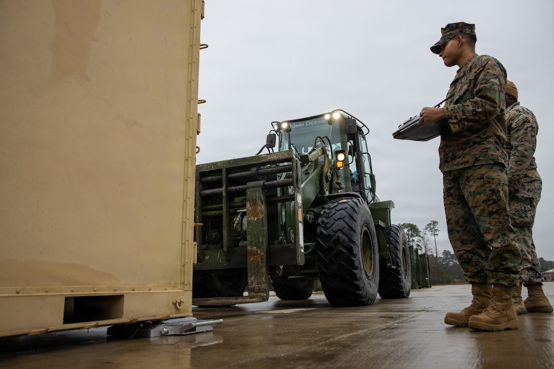 U.S. Marines with II Marine Expeditionary Force Support Battalion, II MEF Information Group, collect embarkation data for equipment at Marine Corps Base Camp Lejeune, North Carolina, Dec. 5, 2025. Marines with II MEF Support Battalion then loaded the equipment in preparation for missions, honing their skills while showcasing the unit’s capabilities to prepare for onward movement at a moment’s notice. (U.S. Marine Corps photo by Cpl. Jack Labrador)