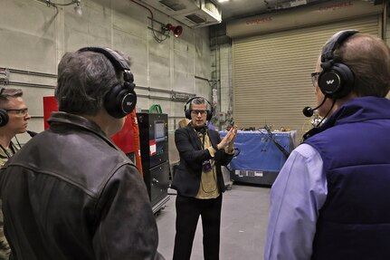 Kate Williams, Directorate of Strategic Management, director, provides a mission and capabilities overview to Sen. Dave McCormick, Rep. John Joyce and staff members inside a maintenance facility during their visit to Letterkenny Army Depot, Dec. 6.