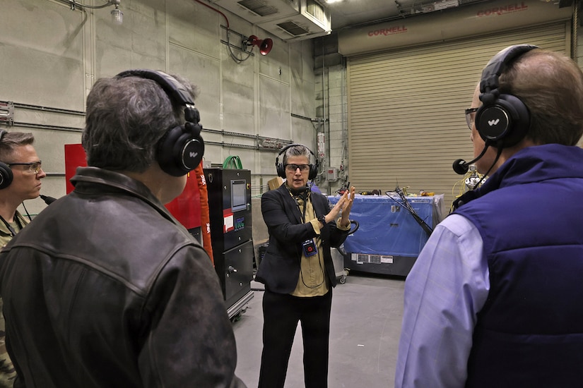 Kate Williams, Directorate of Strategic Management, director, provides a mission and capabilities overview to Sen. Dave McCormick, Rep. John Joyce and staff members inside a maintenance facility during their visit to Letterkenny Army Depot, Dec. 6.