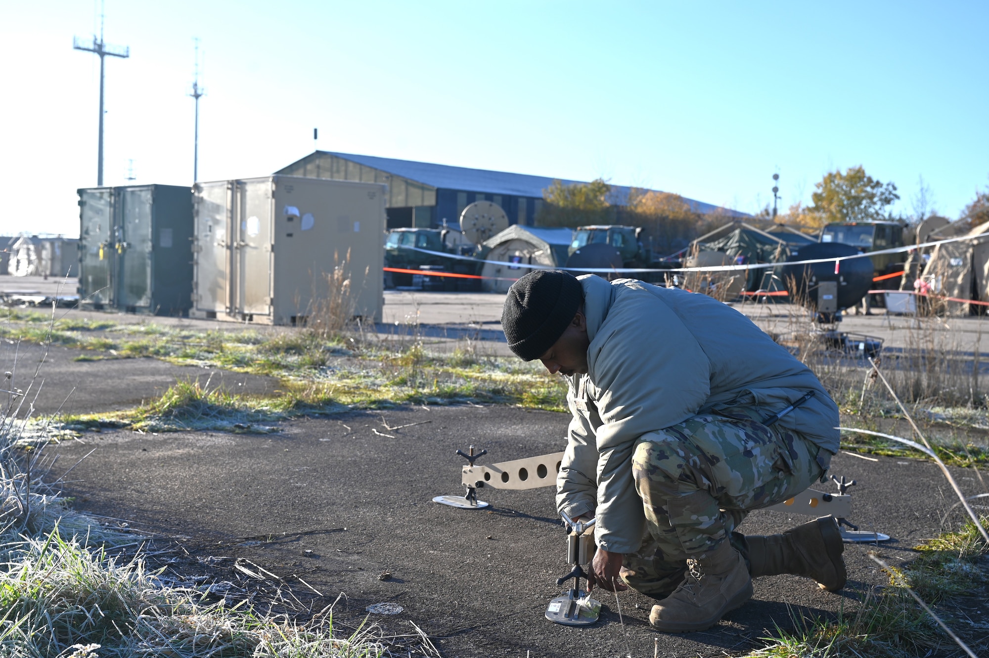 U.S. Air Force Staff Sgt. Devonne Hudson Wallace, 86th Communications Squadron Expeditionary Communications supervisor, assembles a satellite.