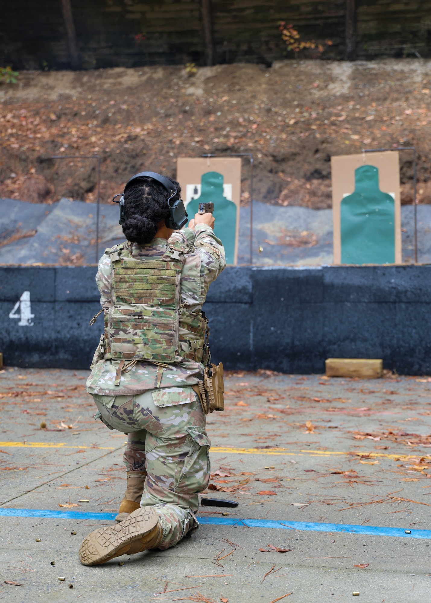 U.S. Air Force Staff Sgt. Taylor J. Holden, 145th Security Forces Squadron team leader, fires the P320-M18 from the kneeling position at the Charlotte-Mecklenburg Police Department Training Academy Range, Charlotte, N.C., Nov. 9, 2025.