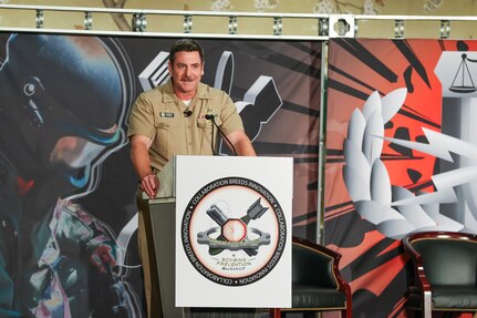 Captain delivers speech to crowd of people at event.