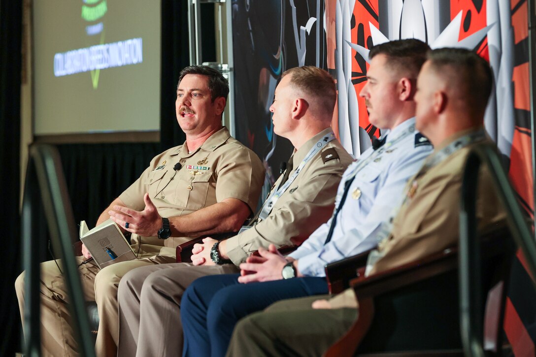 Captain delivers speech to crowd of people at event.