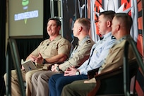 Captain delivers speech to crowd of people at event.