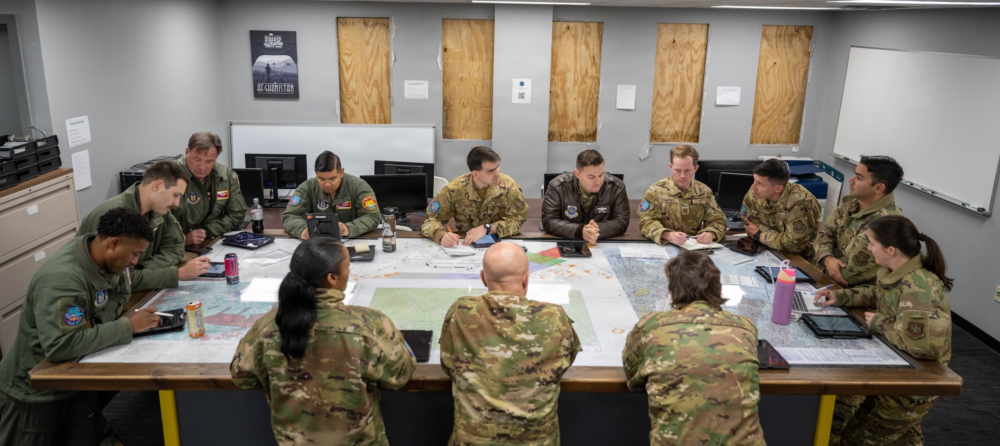 Members of the 22nd and 931st Air Refueling Wings gather around a table for a formation brief at Pope Army Air Field.
