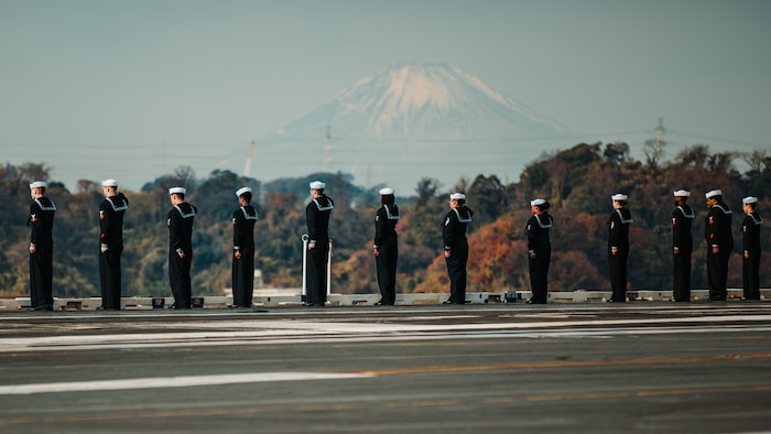 Sailors man the rails on the flight deck as Nimitz-class aircraft carrier USS George Washington (CVN 73) returns to Commander, Fleet Activities Yokosuka, Dec. 11, 2025. George Washington is 7th Fleet’s premier forward-deployed aircraft carrier, a long-standing symbol of the United States’ commitment to maintaining a free and open Indo-Pacific region, while operating alongside Allies and partners across the U.S. Navy’s largest numbered fleet. (U.S. Navy photo by Mass Communication Specialist 2nd Class Tyler Crowley)