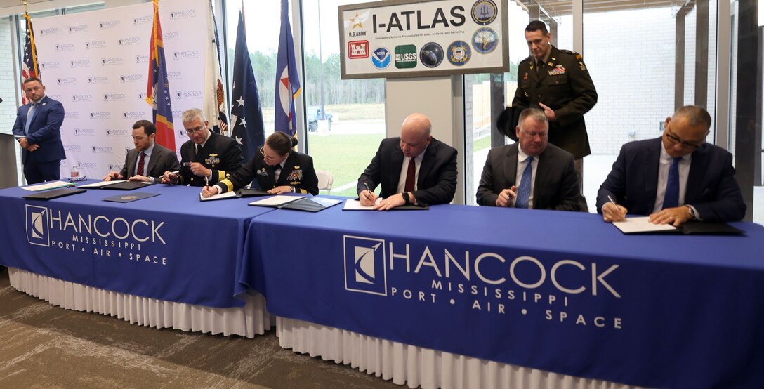 Dignitaries officially sign the Memorandum of Understanding (MOU) at Stennis Airport in Kiln, Mississippi, December 5, 2025. The MOU officially stood up the new I-ATLAS, a joint endeavor of the U.S. Army Corps of Engineers, ERDC, NOAA, NMOC, and the USGS. (U.S. Army photo by Keesha Robinson)