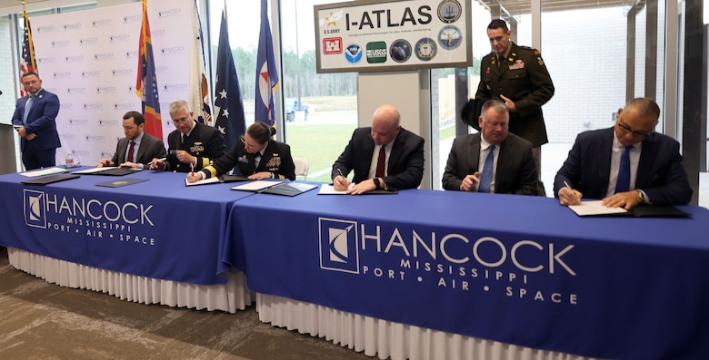 Dignitaries officially sign the Memorandum of Understanding (MOU) at Stennis Airport in Kiln, Mississippi, December 5, 2025. The MOU officially stood up the new I-ATLAS, a joint endeavor of the U.S. Army Corps of Engineers, ERDC, NOAA, NMOC, and the USGS. (U.S. Army photo by Keesha Robinson)