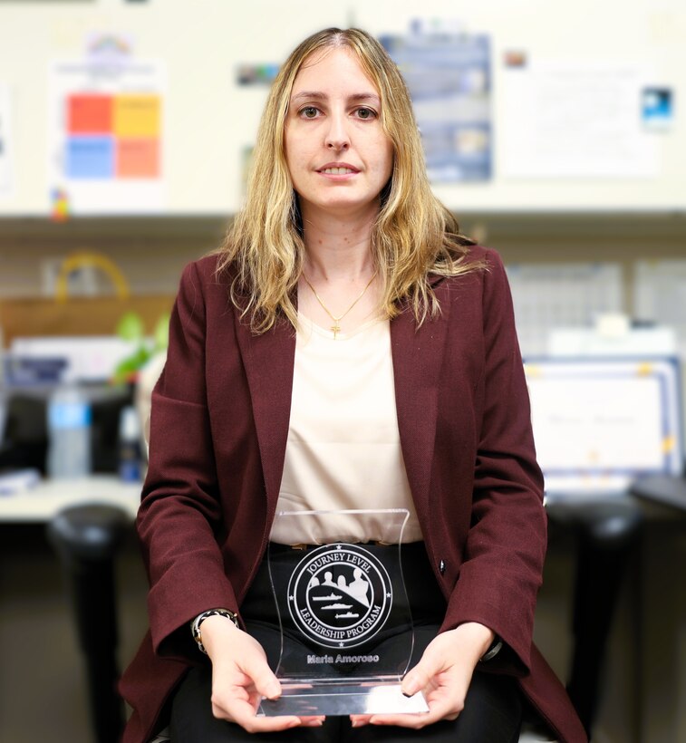 NSWCPD Financial Improvement Audit Remediation (FIAR) Lead Maria Amoroso displays her certificate of completion for the Naval Sea Systems Command (NAVSEA) Journey Level Leadership (JLL) Program. The JLL program aims to develop advanced leadership skills, offer a strategic view of NAVSEA’s enterprise, and boost mission effectiveness through cross-organizational collaboration. (U.S. Navy photo by Spc. Najee Tate-Milton)