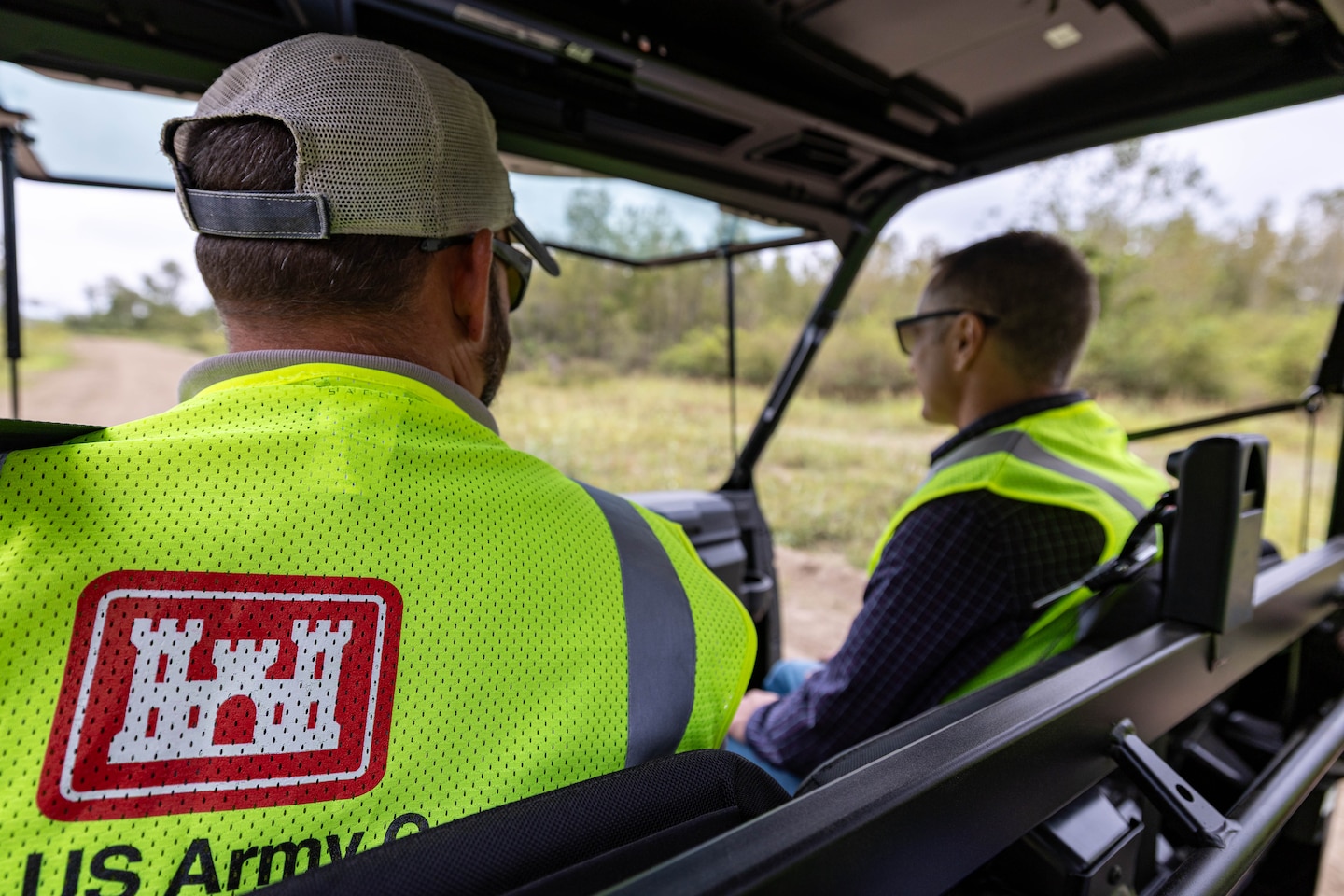 Two Kansas City District senior leaders riding in UTV during site visit to Cora Island.
