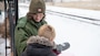 A USACE park ranger helps a young eagle watcher to spot an eagle with a spotting scope.