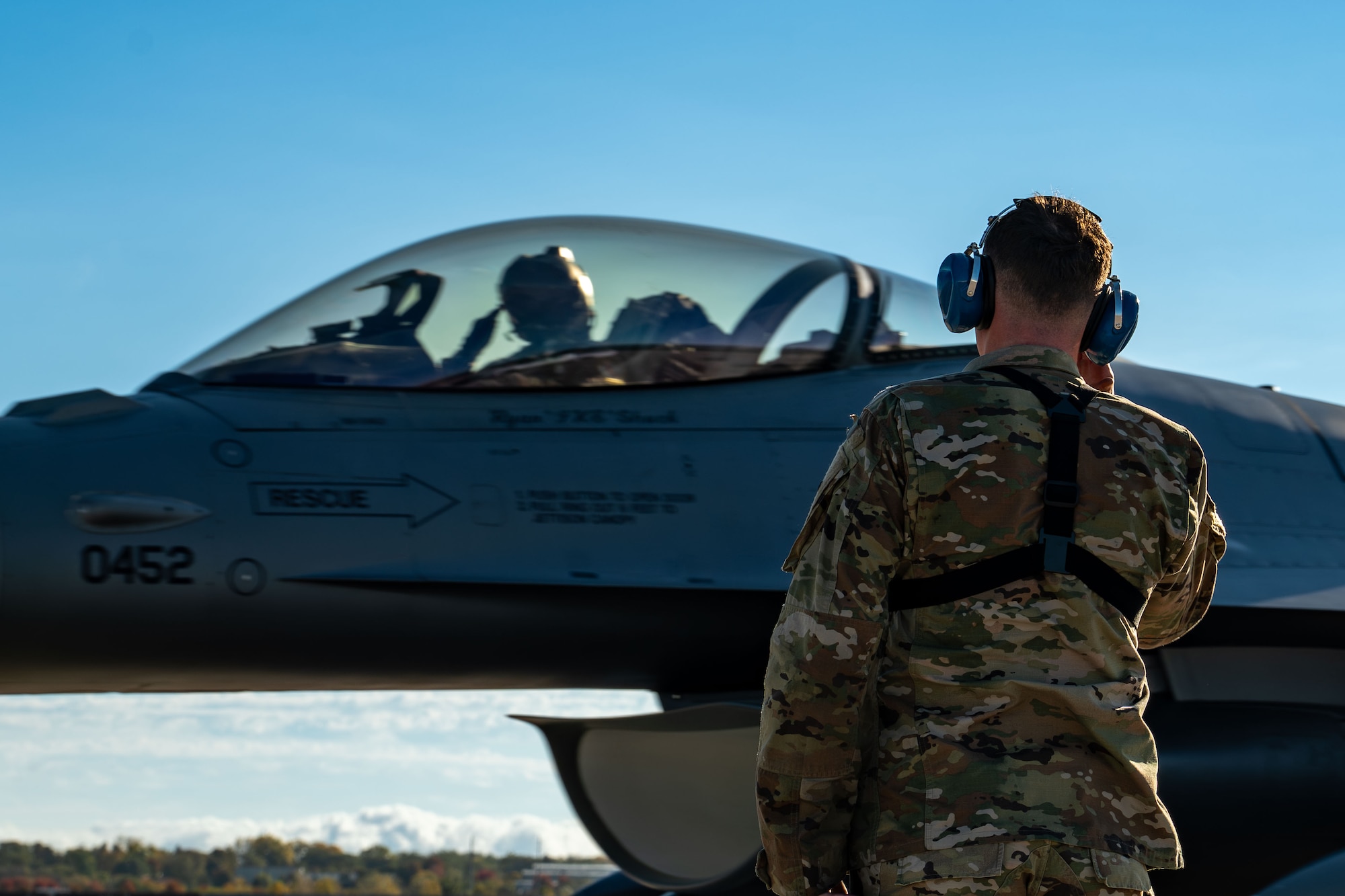 Staff Sgt. Mason Mathieu, a dedicated crew chief with the 114th Aircraft Maintenance Squadron, salutes Col. Brandon Eskam, commander of the 114th Fighter Wing and pilot of tail 452, both with the South Dakota Air National Guard, during operations marking the jet’s 10,000 flight hour milestone at Joe Foss Field, South Dakota, Oct. 17, 2025.