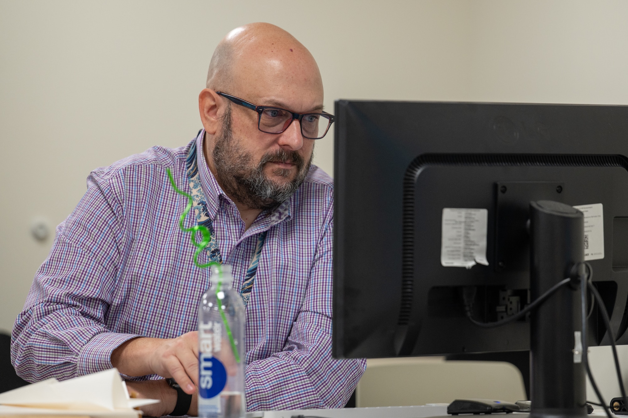 Steve Holdenried, Air Force Test Center management analyst, enters data into a spreadsheet