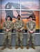 Recruiters posing in front of display.