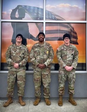 Recruiters posing in front of display.