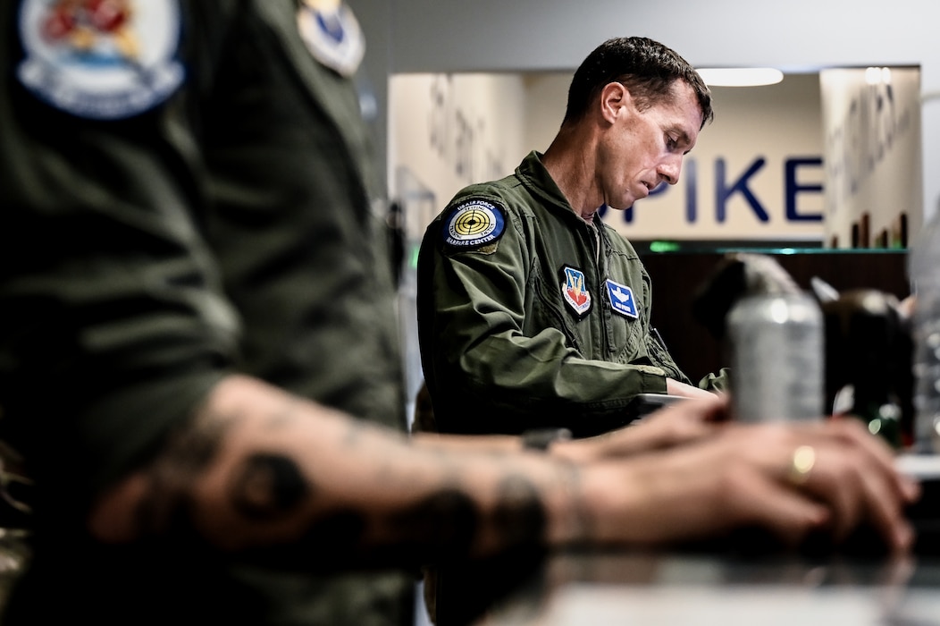 U.S. Air Force Brig. Gen. David Epperson, USAF Warfare Center commander, reviews his flight documentation