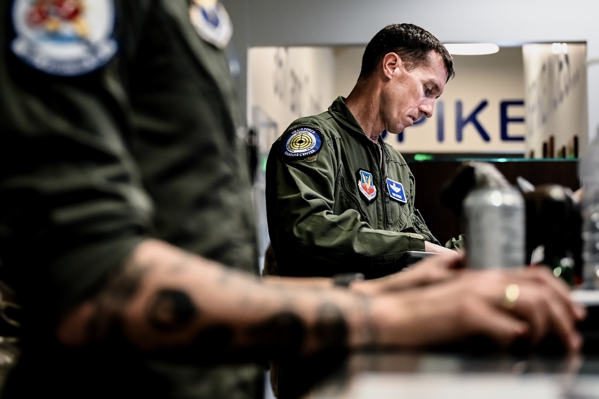 U.S. Air Force Brig. Gen. David Epperson, USAF Warfare Center commander, reviews his flight documentation