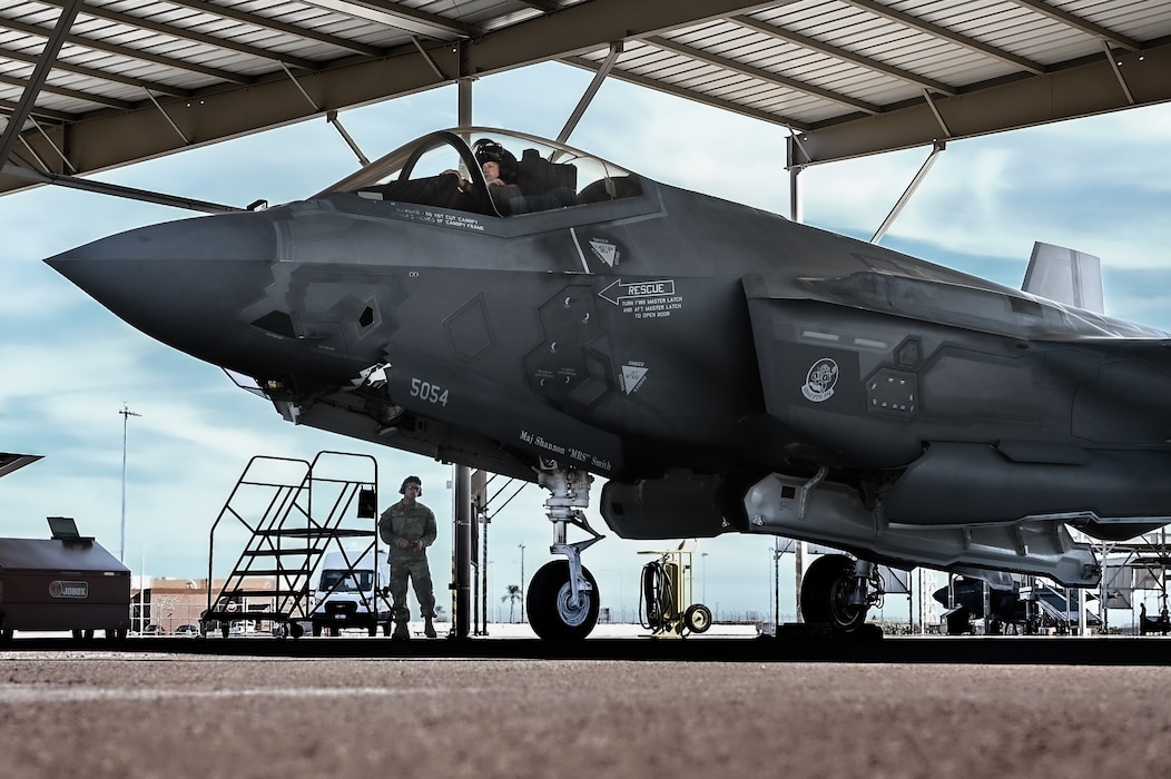 U.S. Air Force Brig. Gen. David Berkland, 56th Fighter Wing commander, secures his helmet in the cockpit of an F-35A Lightning II