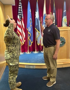 Thomas Casey recites the oath of enlistment on Dec 11, 2025 at the Fort Snelling Military Entrance Processing Station in Minneapolis, Minnesota. Casey started his Air Force career in 1991 as a pavements and construction specialist and retired in 2012 as a military entrance processing station liaison in Minnesota before returning to active duty through the Voluntary Retired Return to Active Duty program in 2025. (courtesy photo)