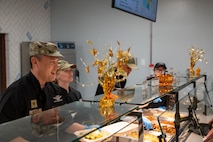 Four Airmen serve a Thanksgiving meal.