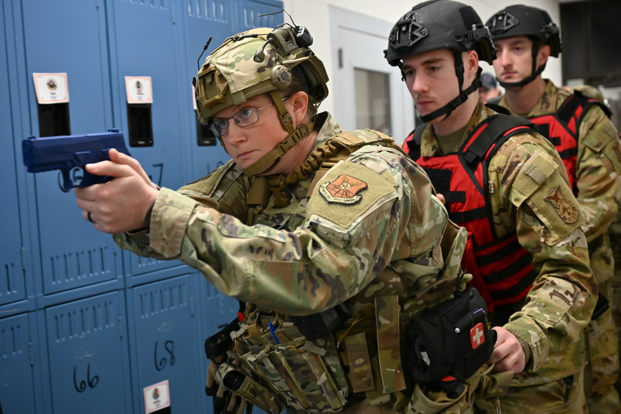Uniformed personnel holds training weapon.