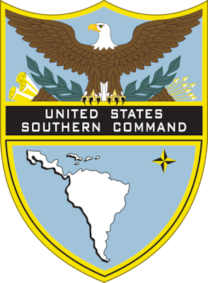 shield of U.S. Southern Command has a bald eagle with it's wings spread, tree branches, arrow, and scrolls atop the U.S. Southern Command title and a map of Latin America underneath.