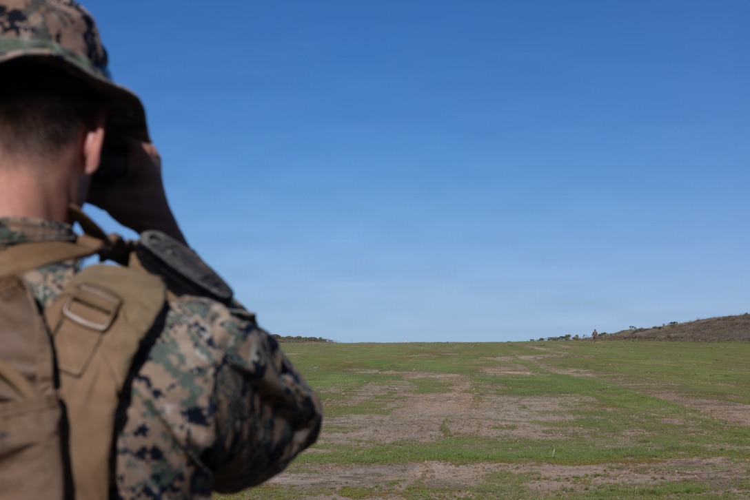 U.S. Marine Corps Sgt. Andres Osborn, a combat engineer with Marine Wing Support Squadron 373, Marine Air Control Group 38, 3rd Marine Aircraft Wing, takes a measurement during reconnaissance and engineering assessments to identify terrain suitability for future Forward Arming and Refueling Point and logistics sites during Steel Knight 25 on San Clemente Island, California, Dec. 4, 2025. These assessments enable 3d MAW to establish expeditionary aviation support sites across distributed and contested environments. Steel Knight is an annual exercise that strengthens the Navy-Marine Corps team's ability to respond forward, integrate across domains, and sustain Marine Air-Ground Task Force readiness. Osborn is a native of California. (U.S. Marine Corps photo by Lance Cpl. Samantha Devine)