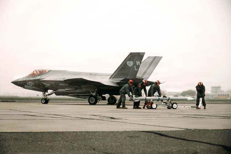 U.S. Marines with Marine Aviation Logistics Squadron 11, Marine Aircraft Group 11, 3rd Marine Aircraft Wing, load ordnance on to an F-35B Lightning II assigned to Marine Fighter Attack Squadron (VMFA) 311 during exercise Steel Knight 25 at Sacramento Mather Airport, California, Dec. 9, 2025. The forward node at Mather enabled aircraft to arm and refuel before launching a simulated Maritime Strike, demonstrating 3rd MAW’s ability to sustain fixed-wing operations from distributed locations. Steel Knight is an annual exercise that strengthens the Navy-Marine Corps team’s ability to respond forward, integrate across domains, and sustain Marine Air-Ground Task Force readiness. (U.S. Marine Corps photo by Sgt. Brian A. Stippey)