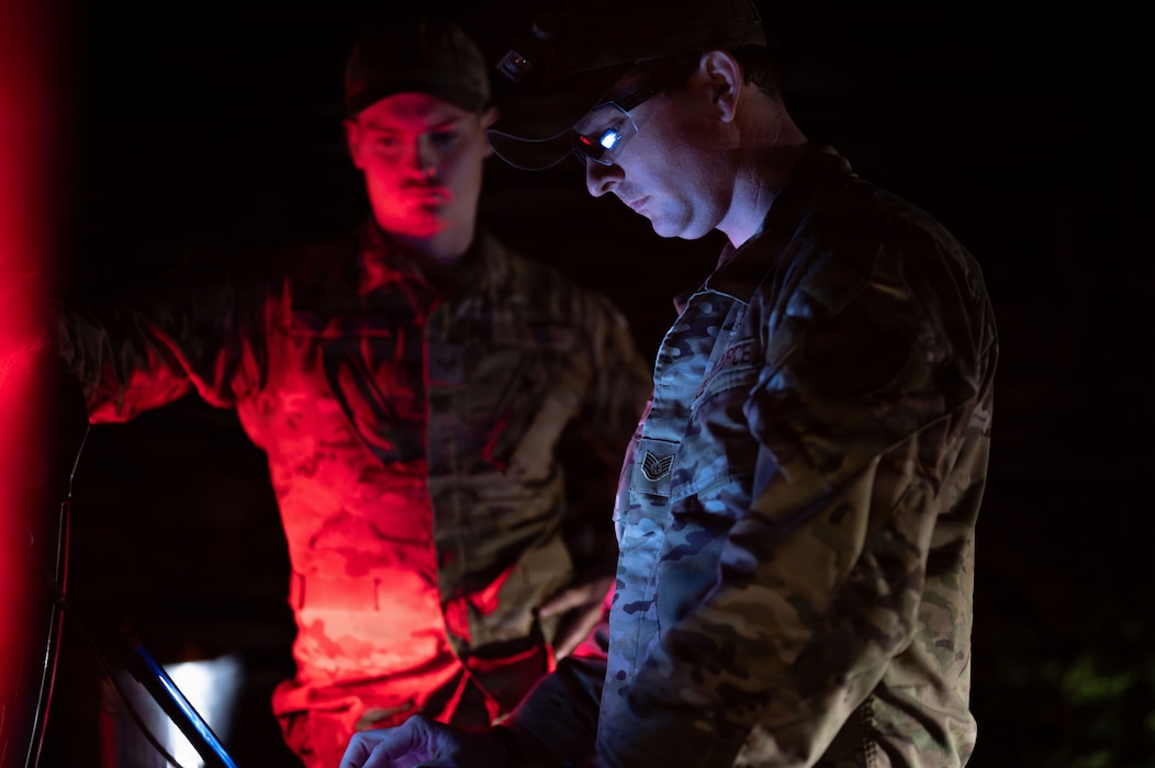 U.S. Air Force Staff Sgt. Bryce Schott, 9th Civil Engineer Squadron (CES) Explosive Ordnance Disposal (EOD) operations non-commissioned officer in charge, and Senior Airman Ace Fry, 9th CES EOD technician assess an Unexploded Ordnance (UXO) in Gualala, California, Dec. 9, 2025.