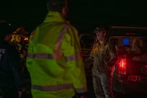 U.S. Air Force Staff Sgt. Bryce Schott, 9th Civil Engineer Squadron (CES) Explosive Ordnance Disposal (EOD) operations non-commissioned officer in charge, briefs local authorities on the disposal procedures for an Unexploded Ordnance (UXO) in Gualala, California, Dec. 9, 2025.