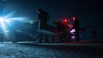 U.S. Marines with Marine Fighter Attack Squadron (VMFA) 242 , 31st Marine Expeditionary Unit, prepare to load ordinance onto an F-35B Lightning II aboard the forward-deployed amphibious assault carrier USS Tripoli (LHA 7), flagship of the Tripoli Expeditionary Strike Group, Dec. 7, 2025, while conducting routine operations in the U.S. 7th Fleet Area of Operations