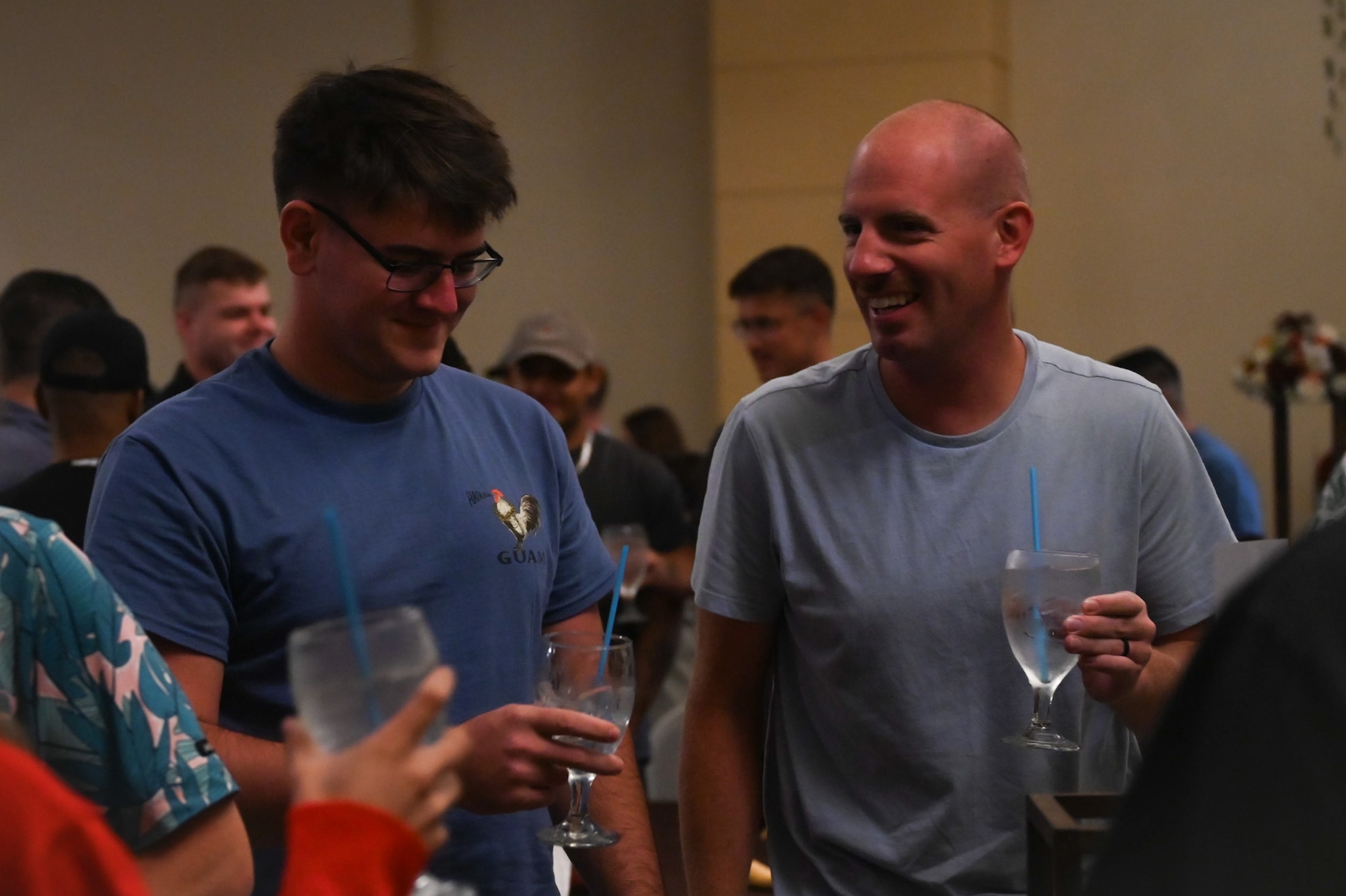 U.S. Air Force Airmen from the 11th Air Task Force sit in a row of chairs while participating in a holiday scavenger hunt during a Thanksgiving team party at Tumon, Guam, Nov. 27, 2025.