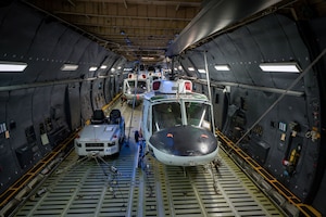 Airman load UH-1N Huey's into a C-5M Super Galaxy assigned to the 22nd Airlift Squadron at Yokota Air Base, Japan, Dec. 3, 2025.