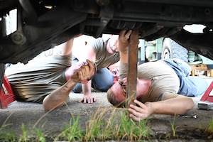 U.S. Air Force Airmen with the 11th Combat Air Base Squadron vehicle maintenance team pose with the Naval Mobile Construction Battalion, also known as the Seabees, after completing projects together at U.S. Naval Base Guam, Dec. 1, 2025.