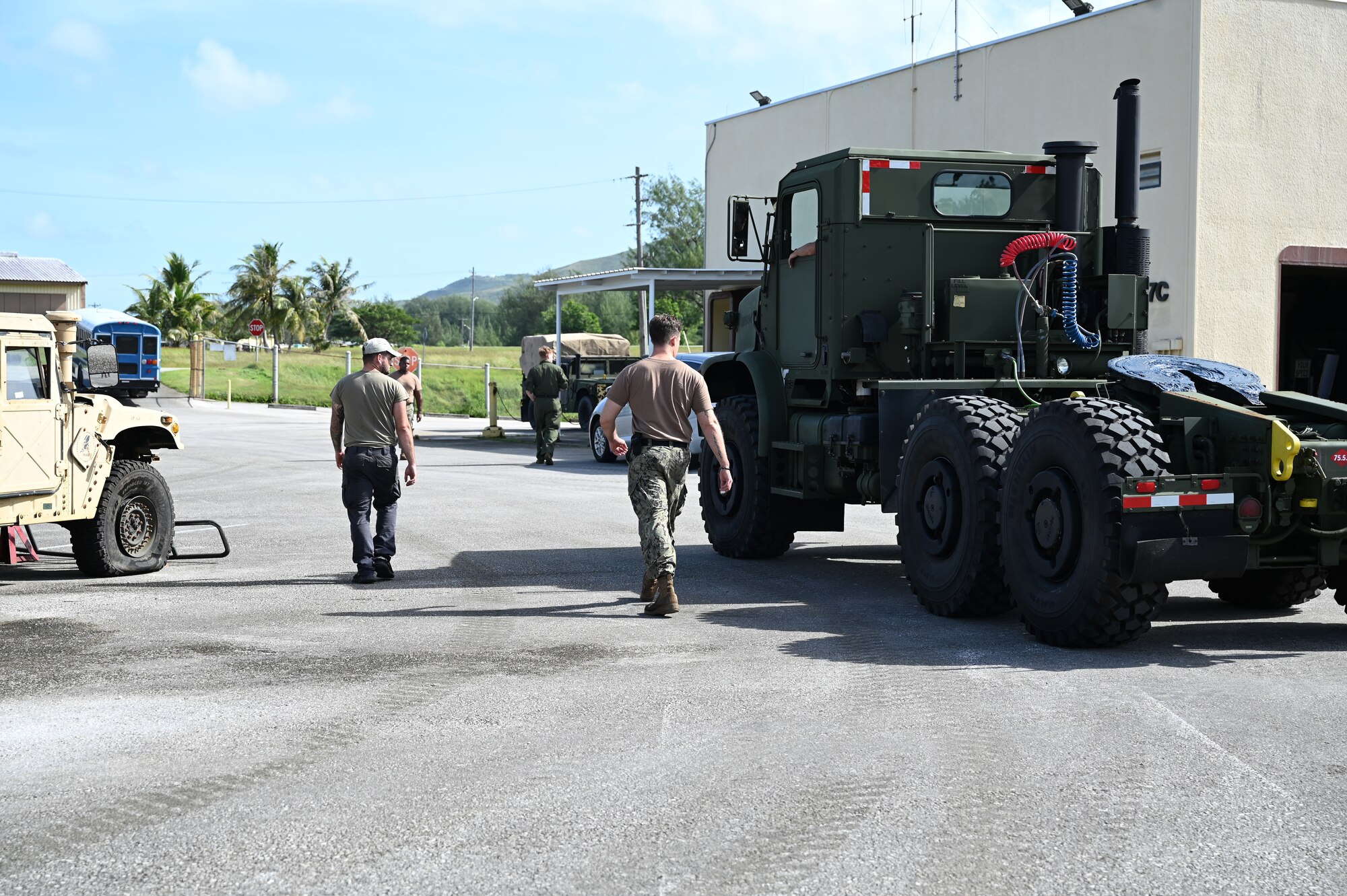 U.S. Air Force Airmen with the 11th Combat Air Base Squadron vehicle maintenance team pose with the Naval Mobile Construction Battalion, also known as the Seabees, after completing projects together at U.S. Naval Base Guam, Dec. 1, 2025.