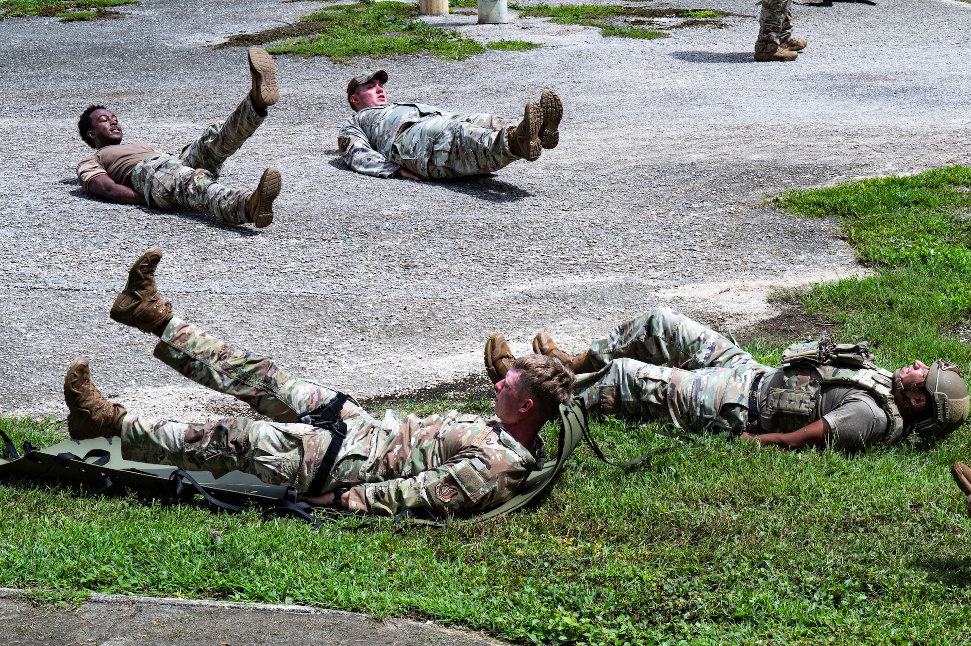U.S. Air Force Airmen with the 11th Combat Air Base Squadron and 824th Base Defense Squadron practice evacuating a simulated patient during training with Airmen from the 36th Security Forces Squadron at Andersen Air Force Base, Guam, Oct. 21, 2025.