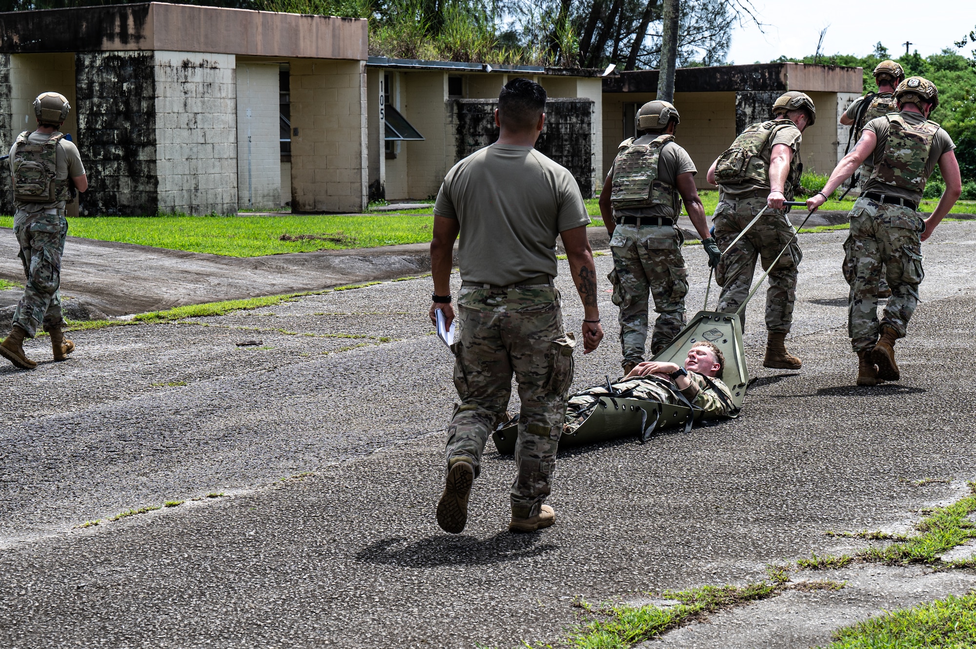 U.S. Air Force Airmen with the 11th Combat Air Base Squadron and 824th Base Defense Squadron practice evacuating a simulated patient during training with Airmen from the 36th Security Forces Squadron at Andersen Air Force Base, Guam, Oct. 21, 2025.