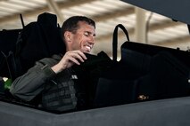 U.S. Air Force Brig. Gen. David Epperson, USAF Warfare Center commander, checks his gear in the cockpit of an F-35A Lightning II