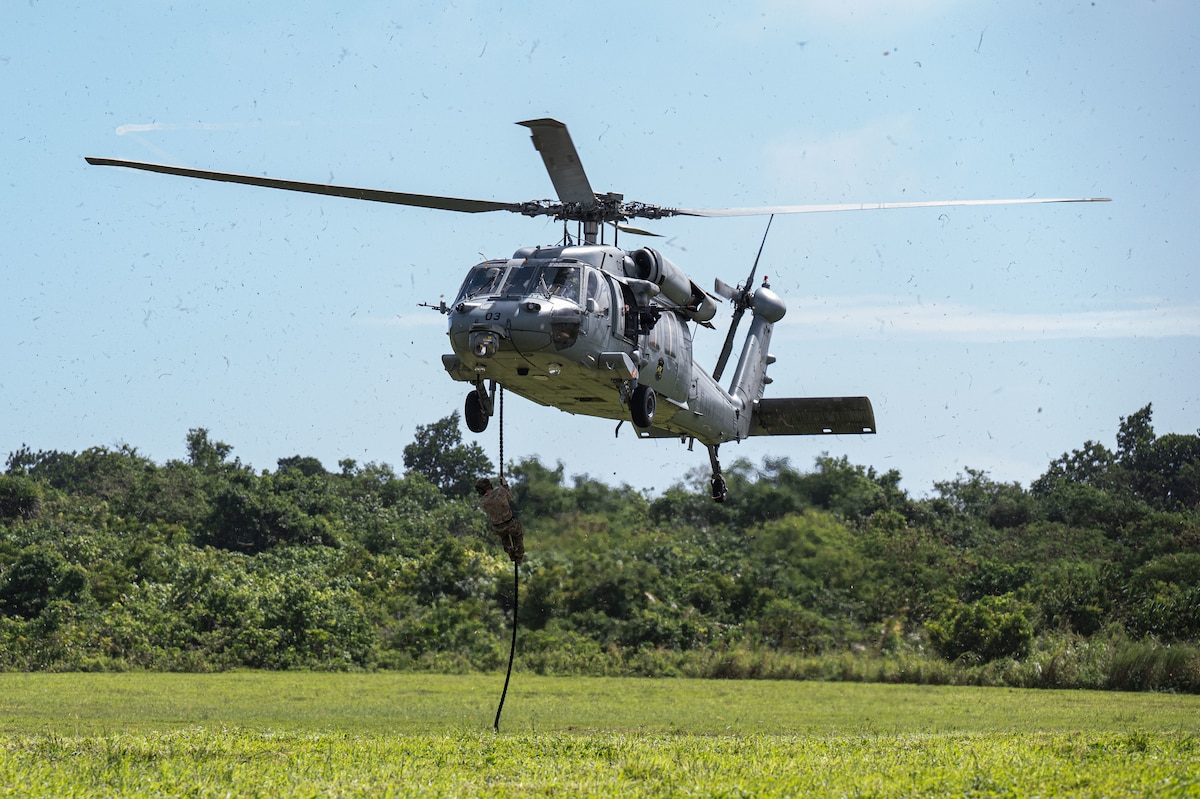 U.S. Air Force Airmen with the 11th Combat Air Base Squadron and 824th Base Defense Squadron prepare for fast-rope insertion training with Helicopter Sea Combat Squadron 25 at Andersen Air Force Base on Nov. 20, 2025.