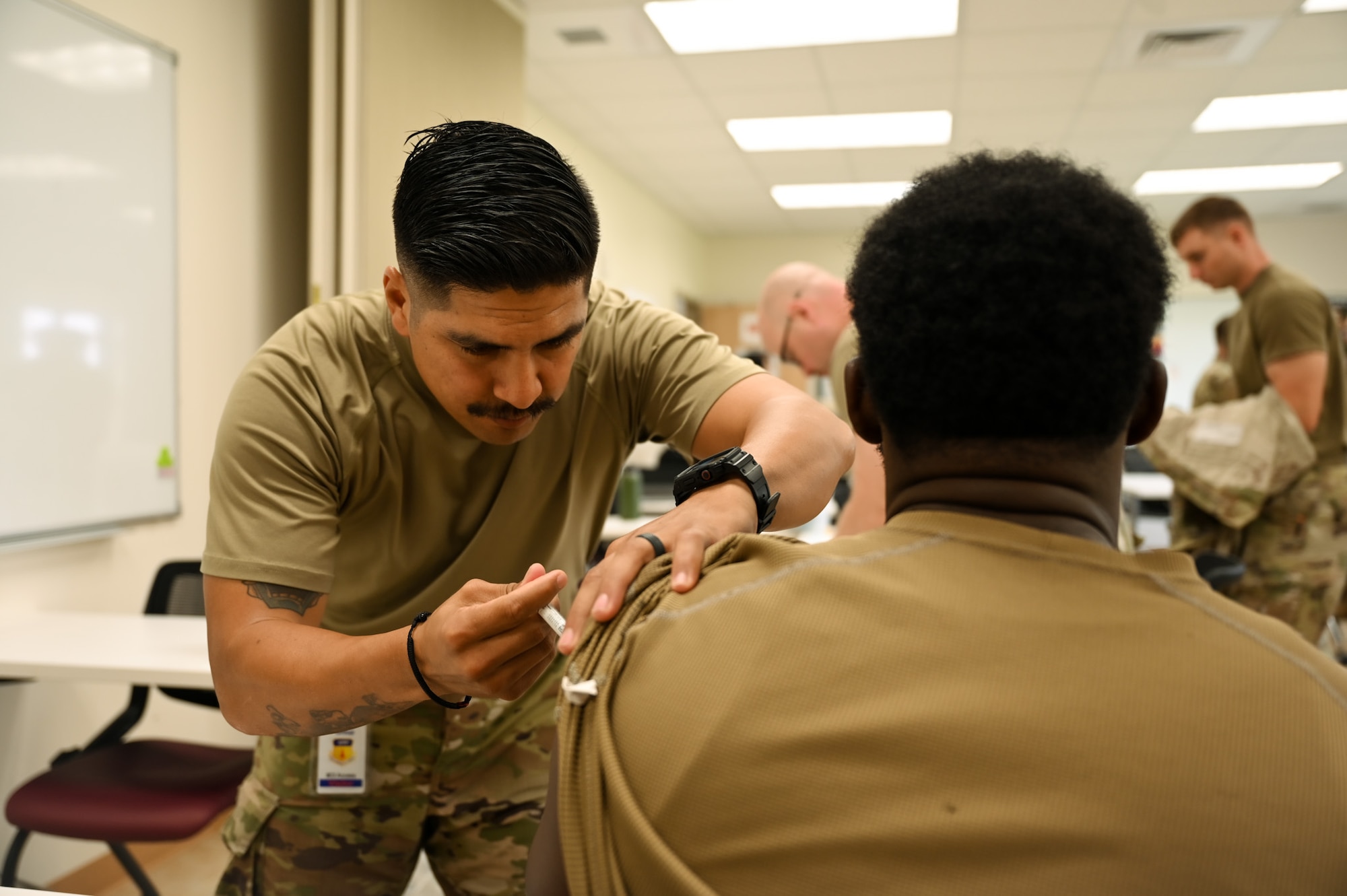 U.S. Air Force Chief Master Sgt. Sharreen Taylor, 11th Air Task Force command chief, gets her shoulder sterilized before receiving the northern influenza flu shot at Andersen Air Force Base, Guam, Oct. 7, 2025.