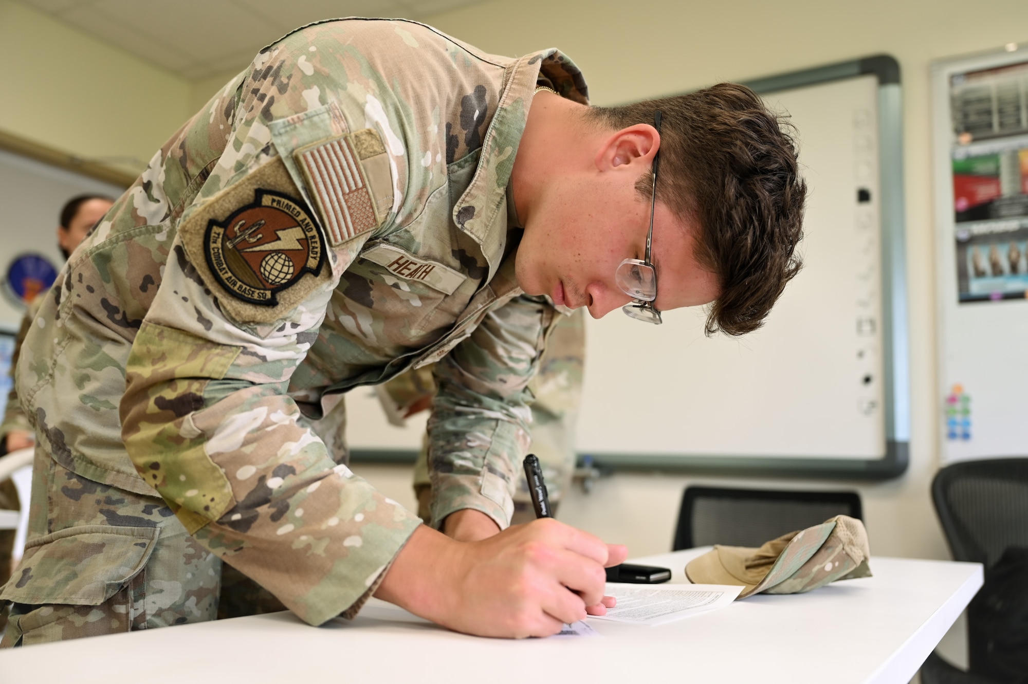 A U.S. Air Force Airman with the 11th Combat Air Base Squadron signs his name into the accountability roster to track his information when receiving the northern influenza flu shot at Andersen Air Force Base, Guam, Oct. 7, 2025.