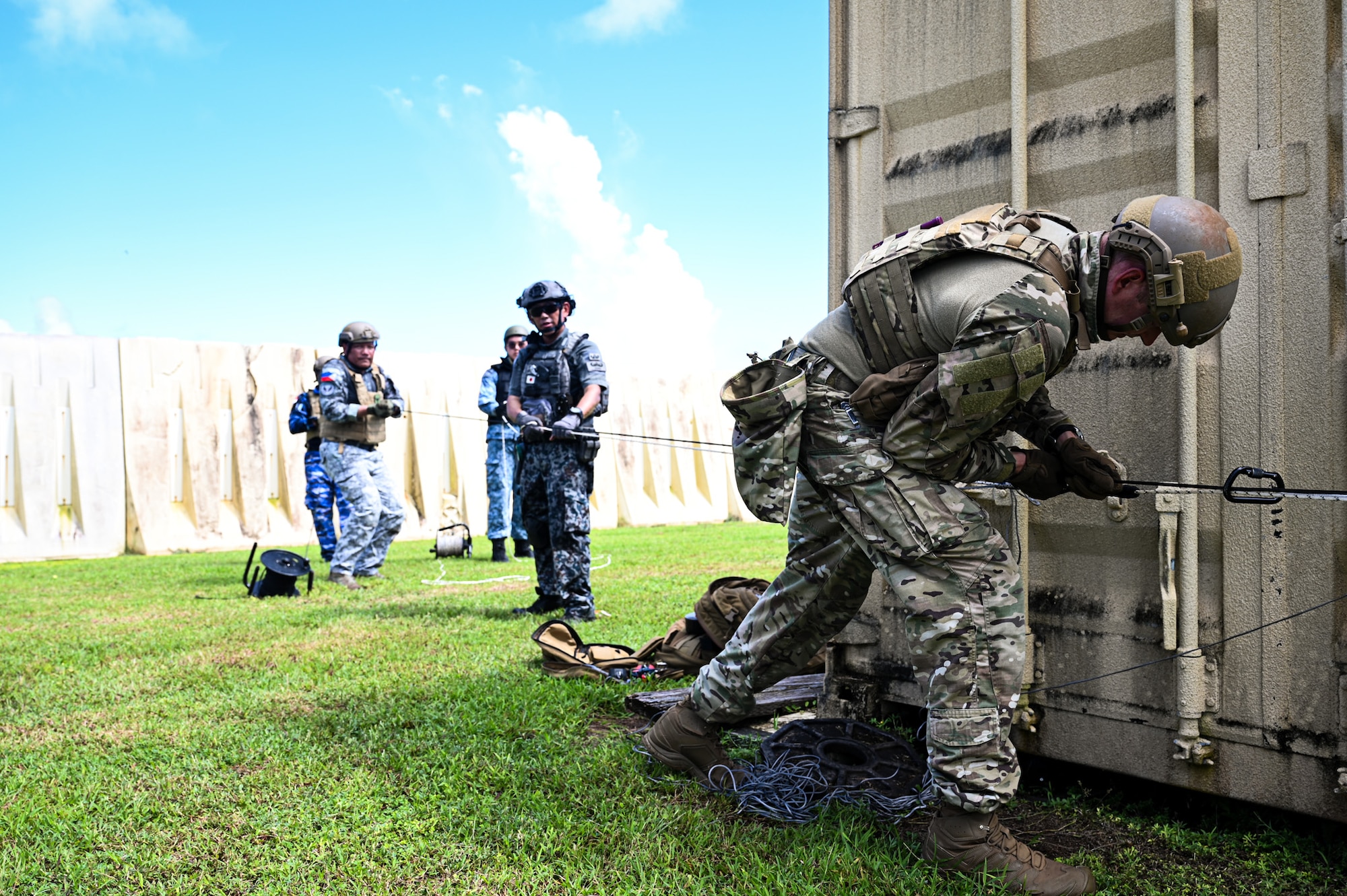 A combined team with members from the 11th Combat Air Base Squadron, other U.S. military units, Japan, Indonesia, the Philippines and Singapore establish a lever and pulley system to remove a simulated Hellfire missile from a building during exercise Silver Flag at Andersen Air Force Base, Guam, Sept. 25, 2025.