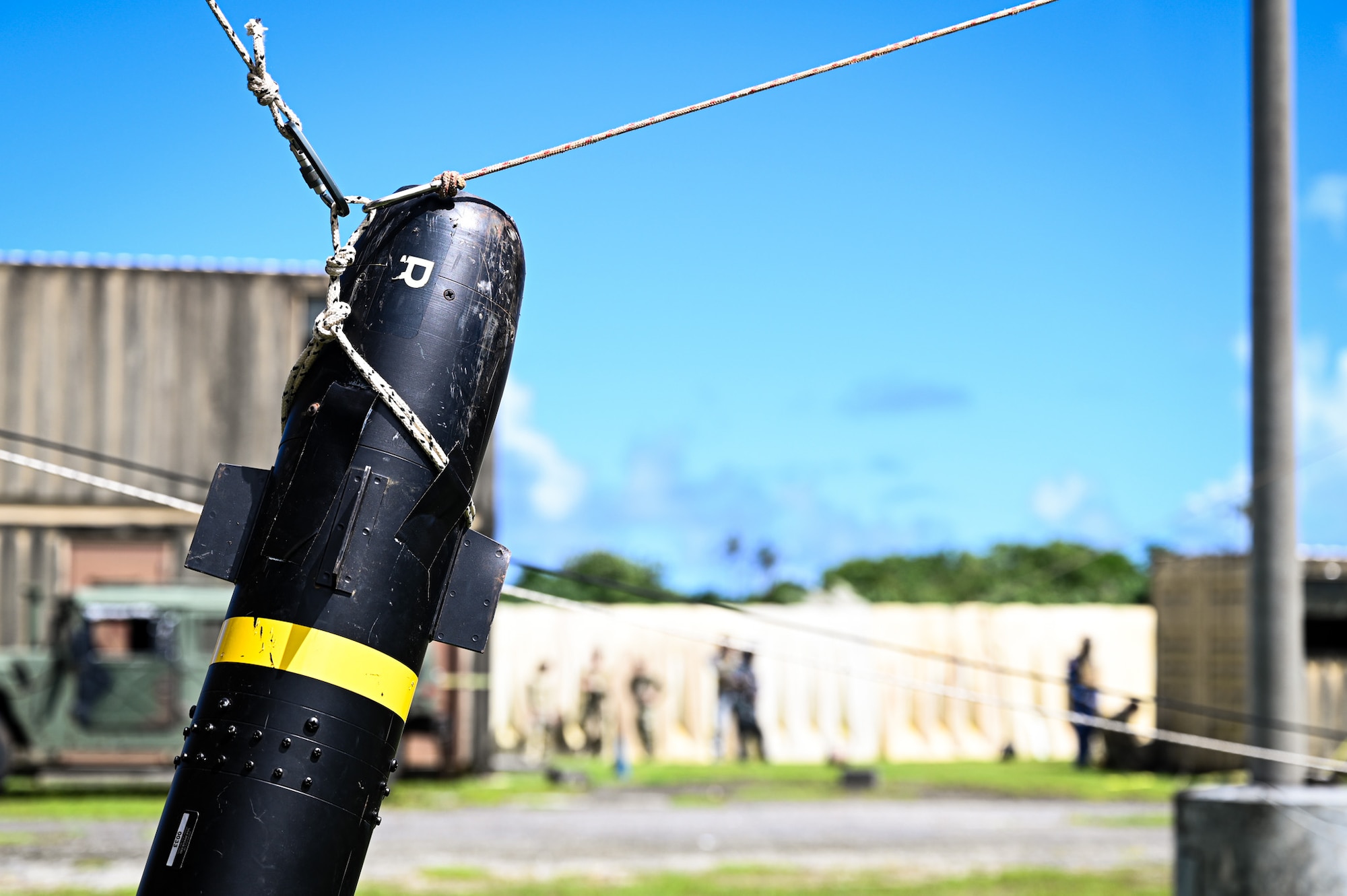 A combined team with members from the 11th Combat Air Base Squadron, other U.S. military units, Japan, Indonesia, the Philippines and Singapore establish a lever and pulley system to remove a simulated Hellfire missile from a building during exercise Silver Flag at Andersen Air Force Base, Guam, Sept. 25, 2025.