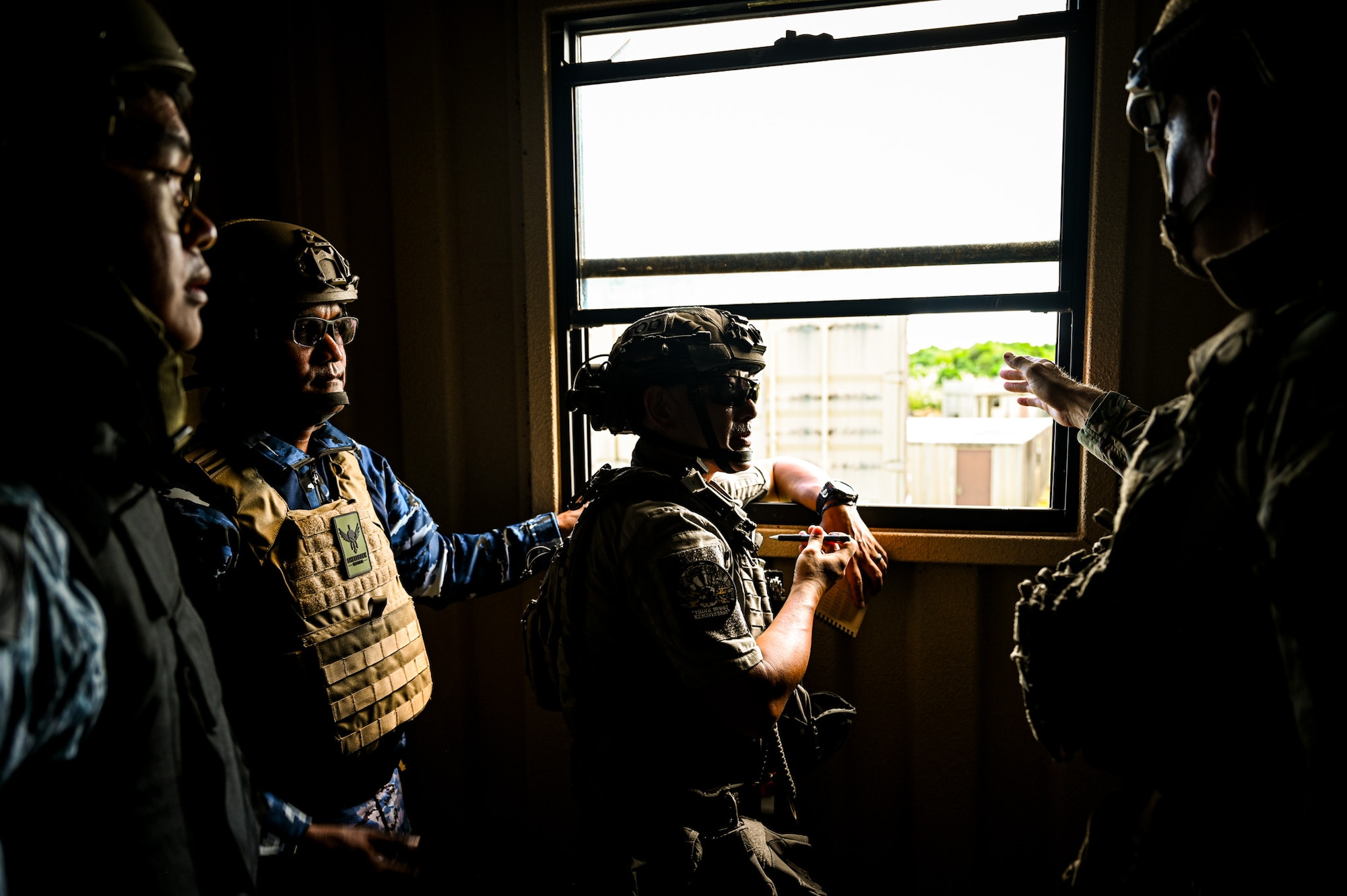 A combined team with members from the 11th Combat Air Base Squadron, other U.S. military units, Japan, Indonesia, the Philippines and Singapore establish a lever and pulley system to remove a simulated Hellfire missile from a building during exercise Silver Flag at Andersen Air Force Base, Guam, Sept. 25, 2025.