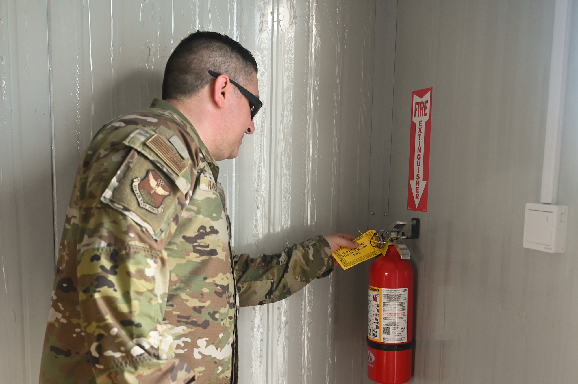 A U.S. Air Force Airman with the 11th Air Task Force safety team performs a fire extinguisher inspection during exercise Resolute Force Pacific in Saipan, Northern Mariana Islands, July 14, 2025.