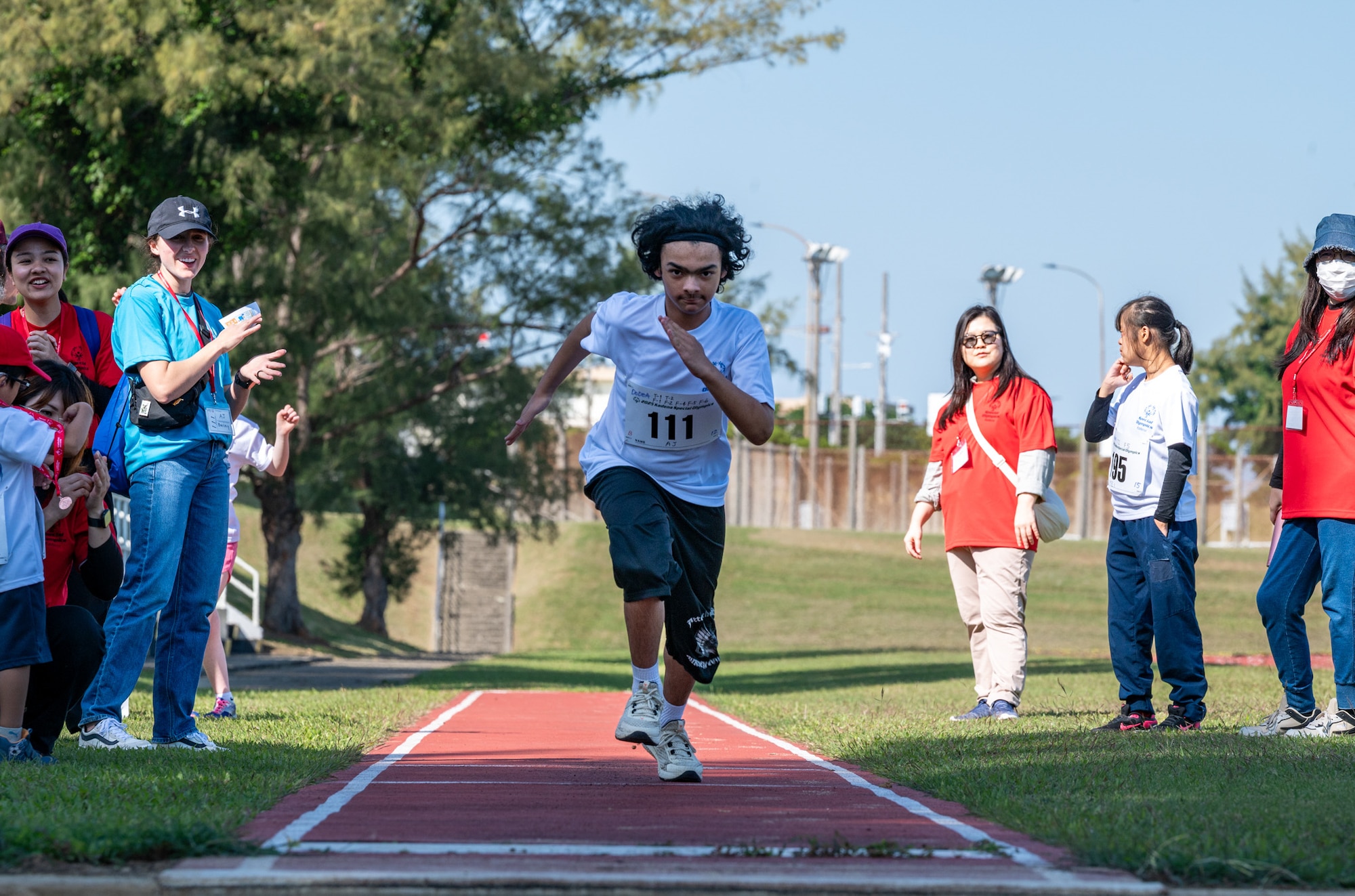 A Kadena Special Olympics athlete competes in a long jump event during the Kadena Special Olympics at Kadena Air Base, Japan, Dec. 6, 2025. Established by the 18th Wing commander in 1999, KSO is a sporting and outreach event providing opportunities for U.S. and Okinawan communities to band together in support of people with disabilities. (U.S. Air Force photo by Senior Airman Erin Currie)