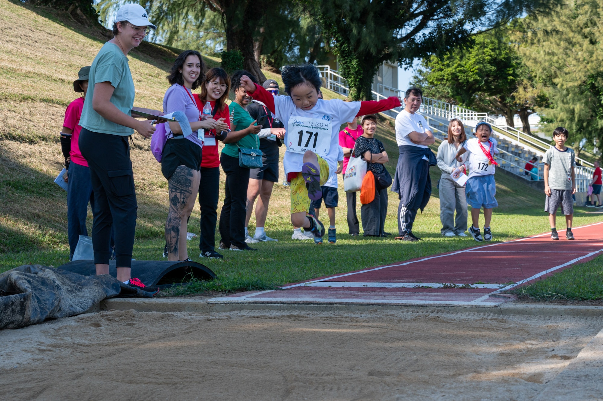 A Kadena Special Olympics athlete competes in a long jump event during the Kadena Special Olympics at Kadena Air Base, Japan, Dec. 6, 2025. This year 104 athletes that registered, 14 American and 91 local contestants competed, all united in the endeavor to showcase the results of their diligent training.  (U.S. Air Force photo by Senior Airman Erin Currie)