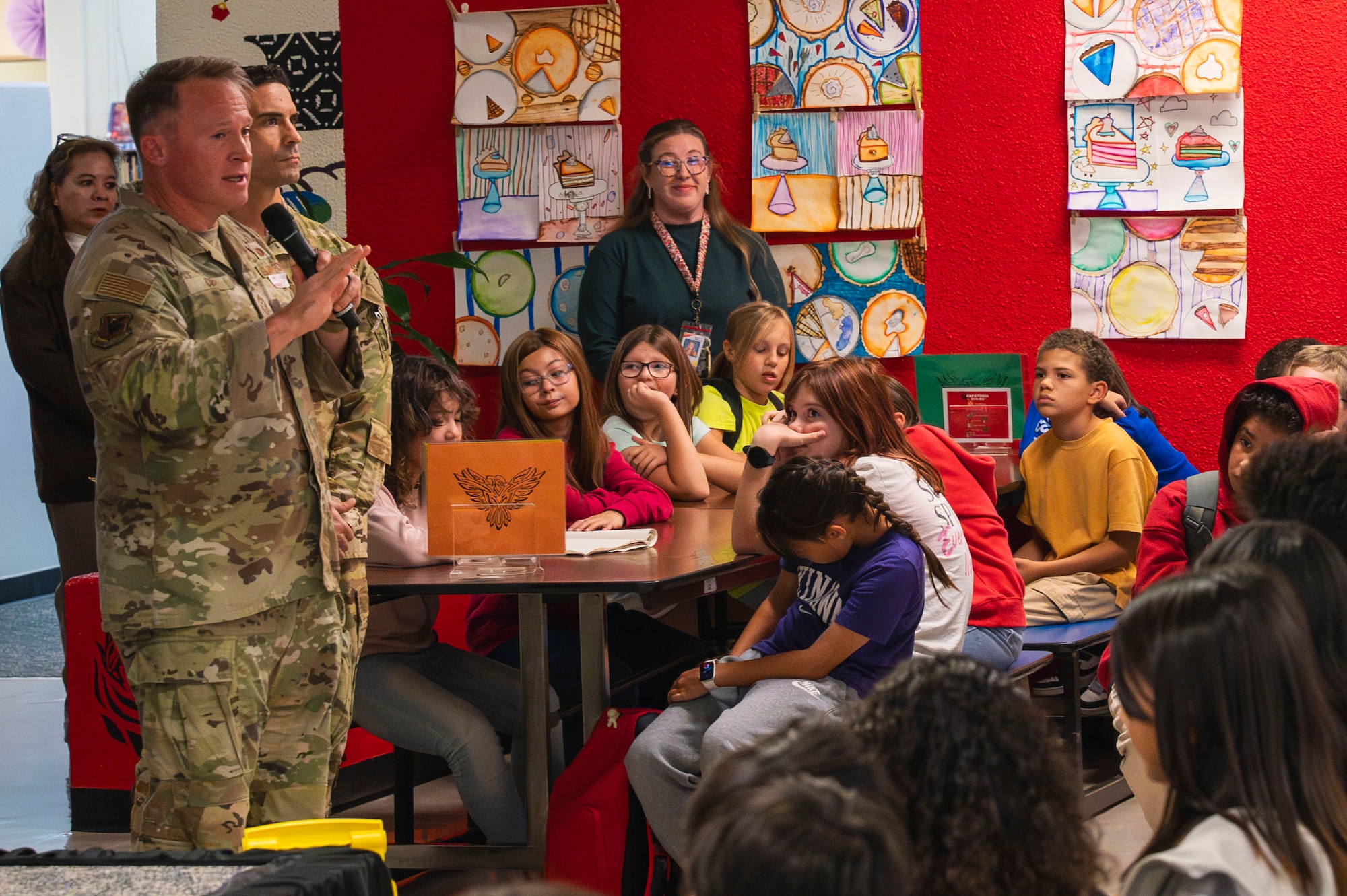 U.S. Air Force Chief Master Sgt. William Cupp, 18th Wing command chief, talks with Amelia Earhart Intermediate School students.