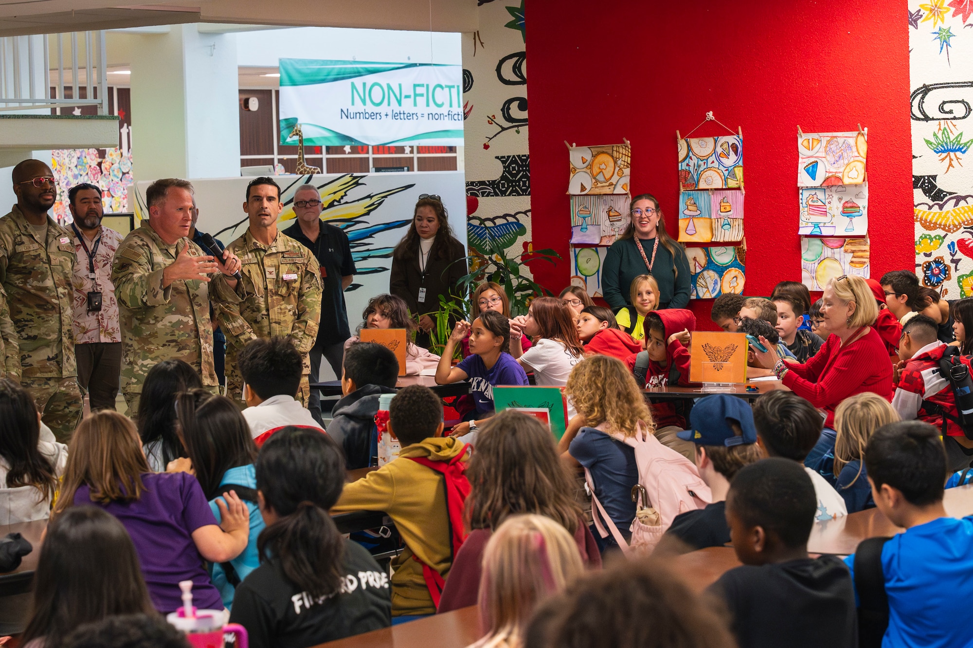 Service members talk to students at Amelia Earhart Intermediate School.